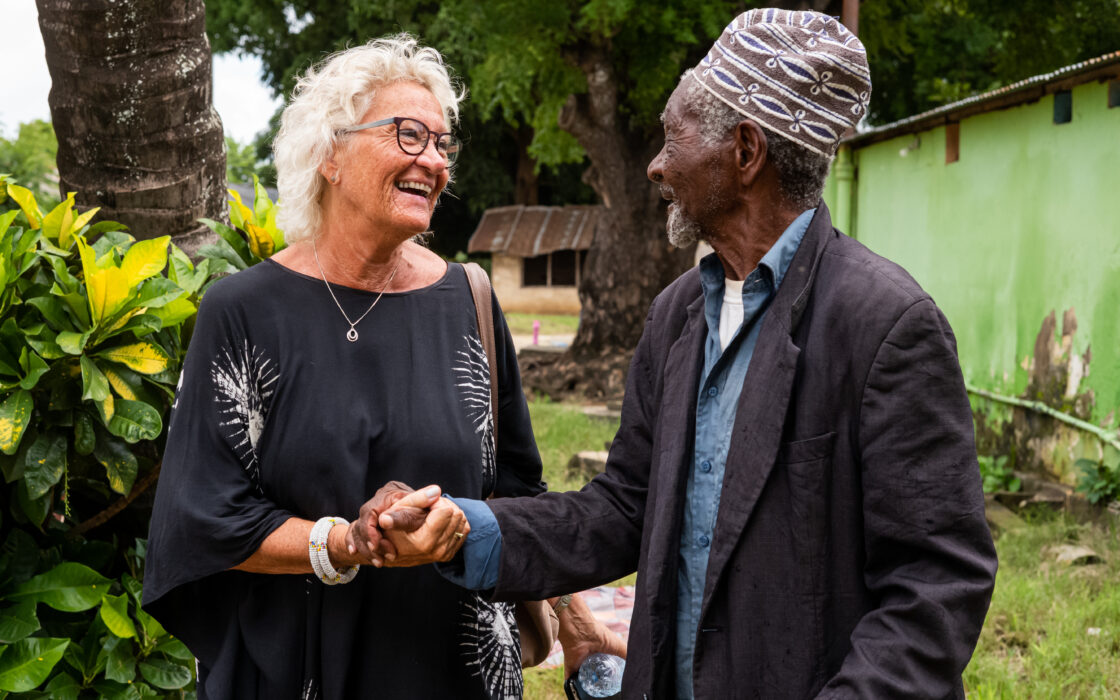 Ruth Nesje handshaking a resident of the elderly home