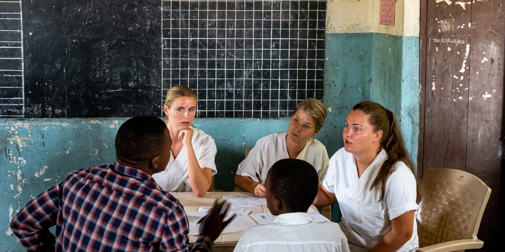 Students assessing a child with his father