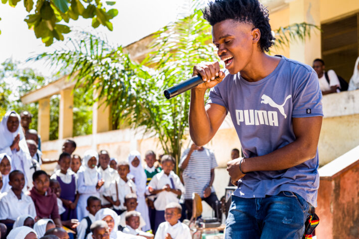 Member of the Youth Group Program singing in a campaign