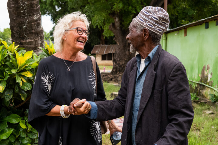 Ruth Nesje handshaking a resident of the elderly home