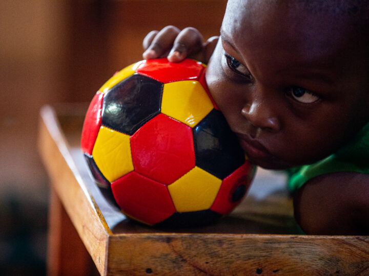 Child paying attention while holding a football